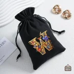 Bourse à dés alphabet avec motifs floraux